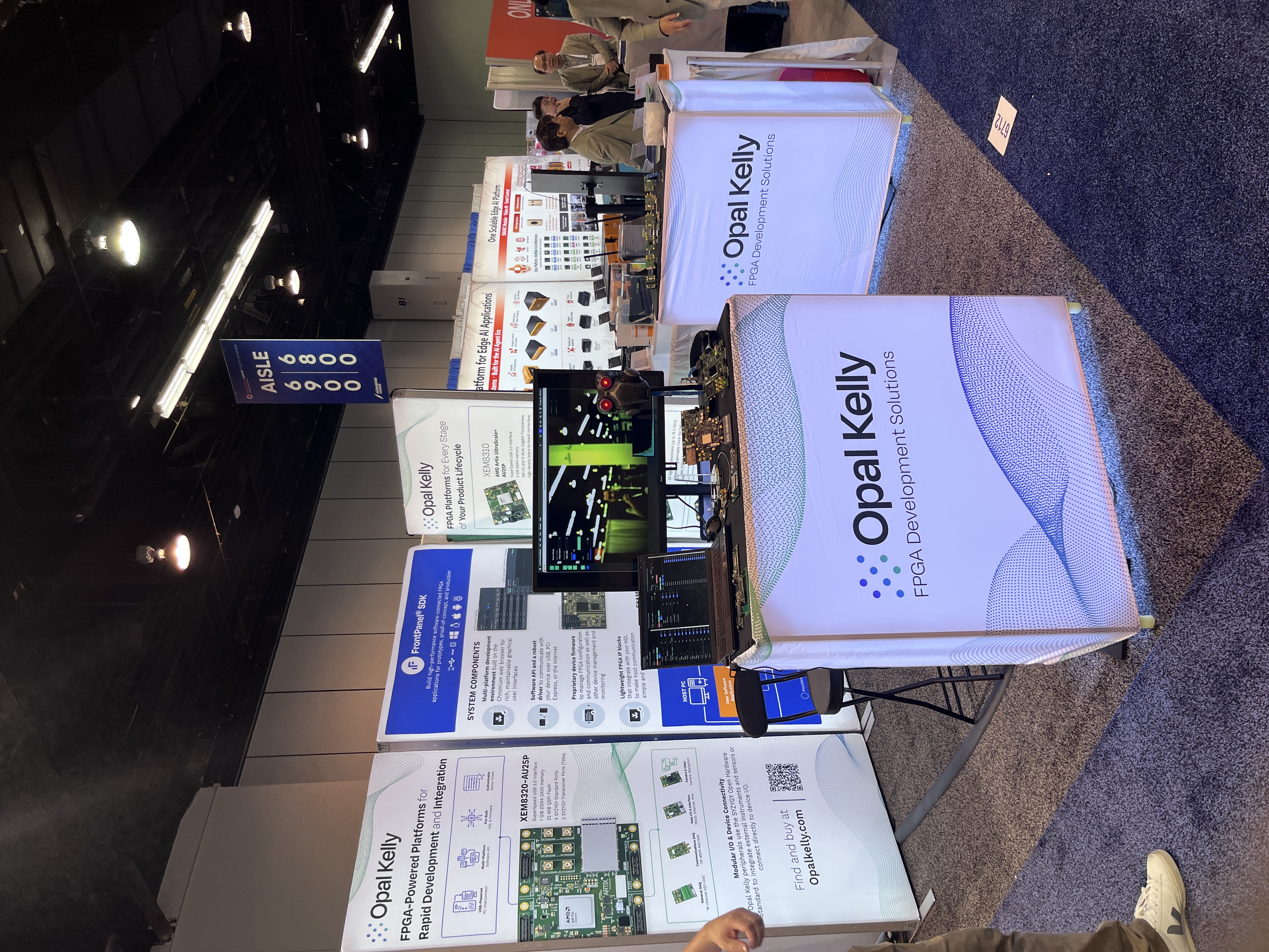 The Opal Kelly booth at Embedded World North America 2026, with the demo counter, display counter, and FrontPanel and product backdrops